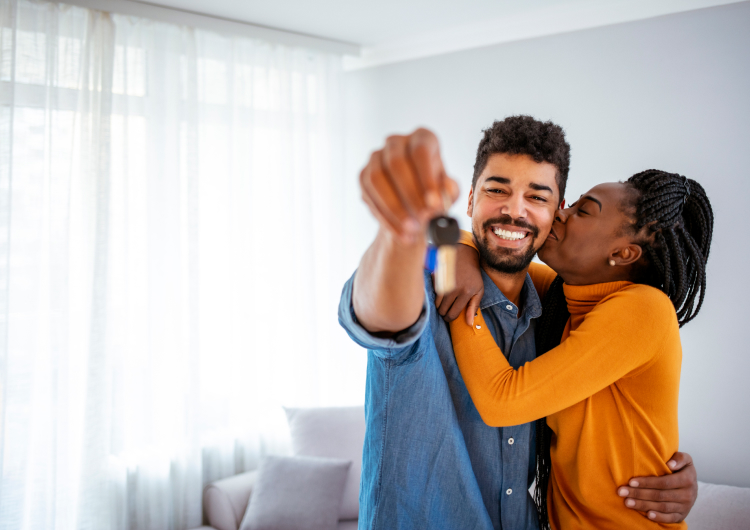 Couple hugging with keys